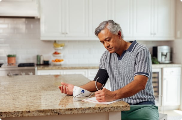 man checking his blood pressure at home