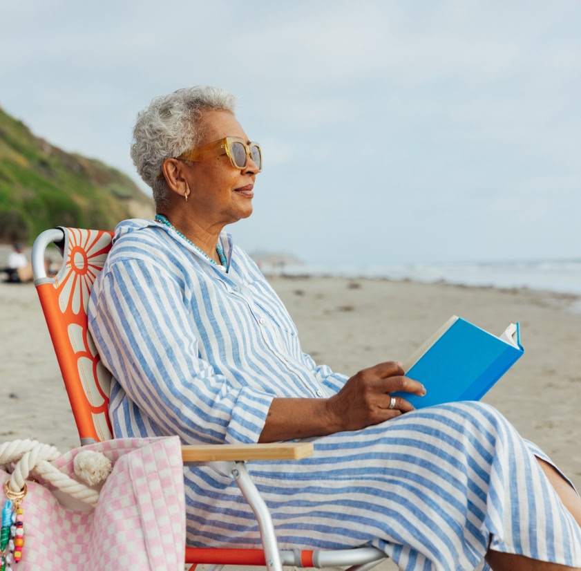 woman reading a book at the beach